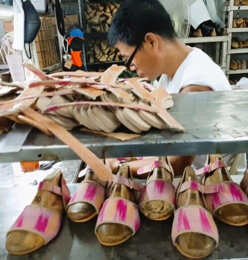 A shoemaker making Holalili shoes